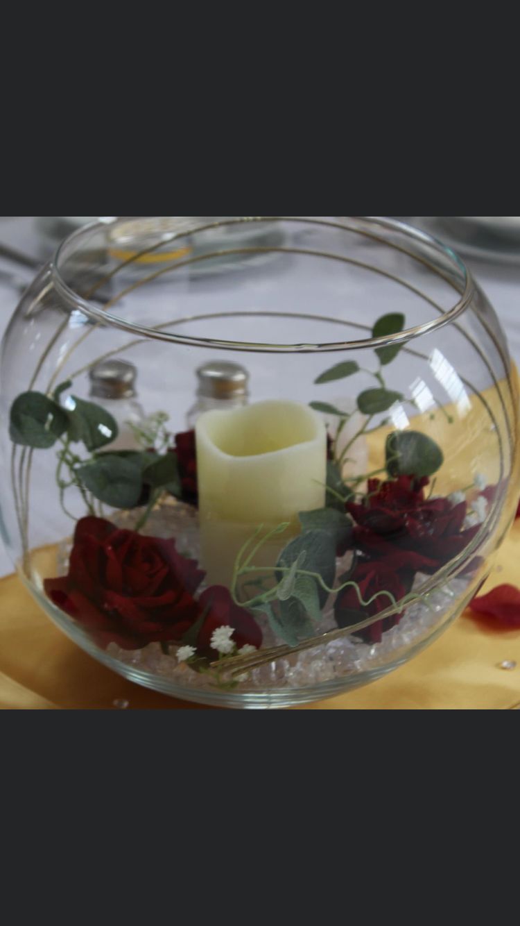 Fish bowl centrepiece with candle and red roses