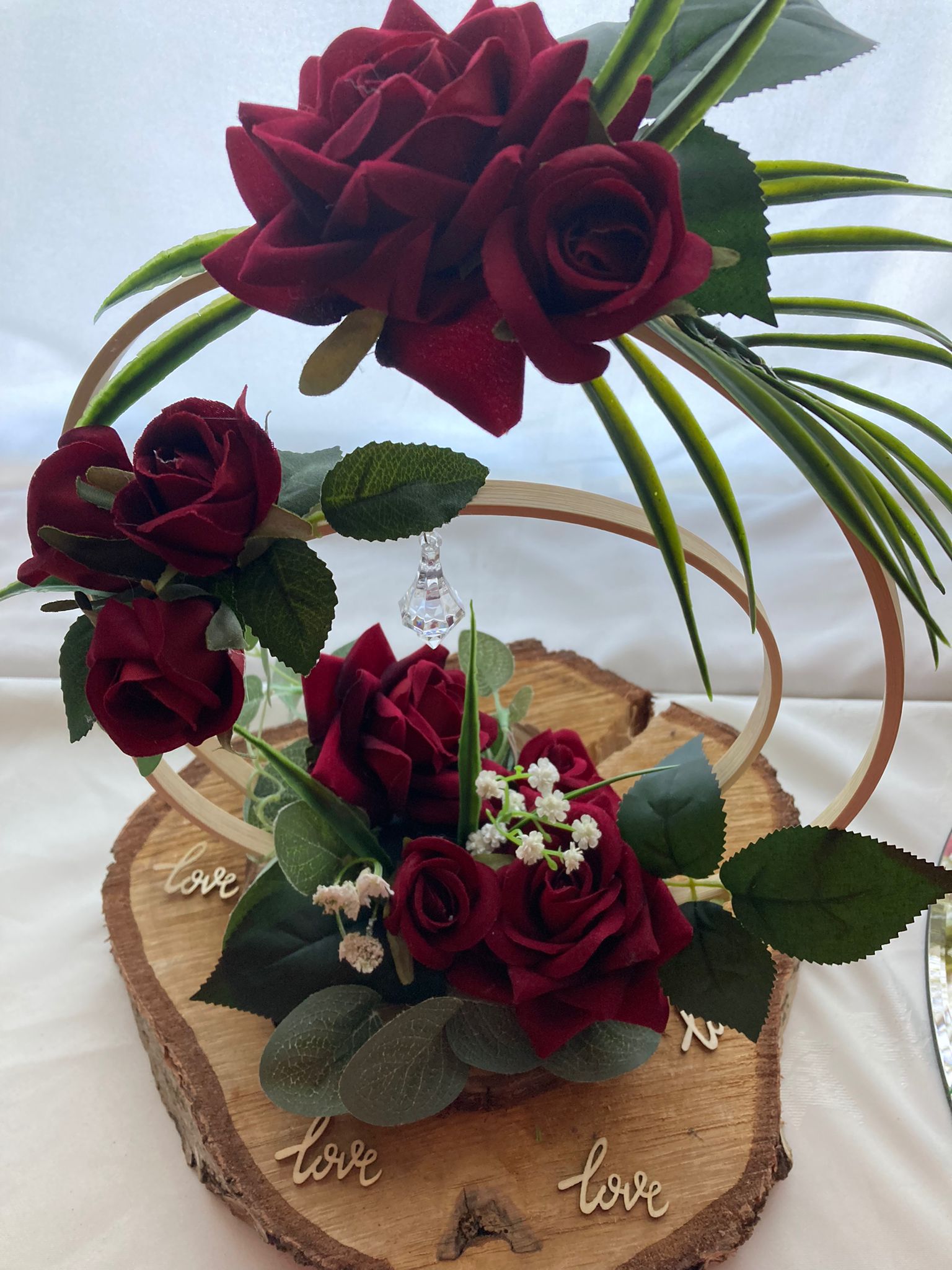 Wooden hoop centrepieces with red rose flowers