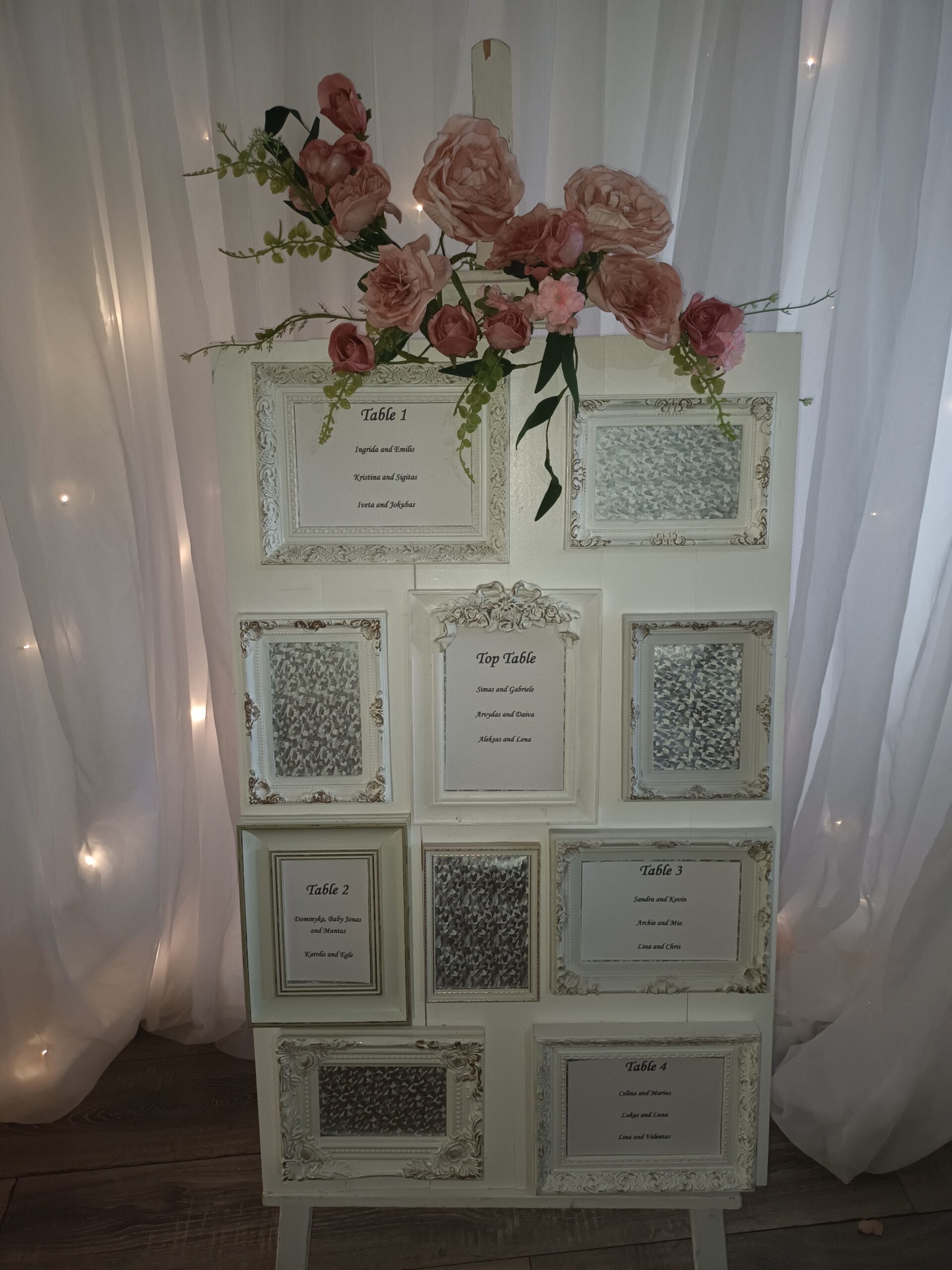 White seating plan with individual frames, decorated in pink roses