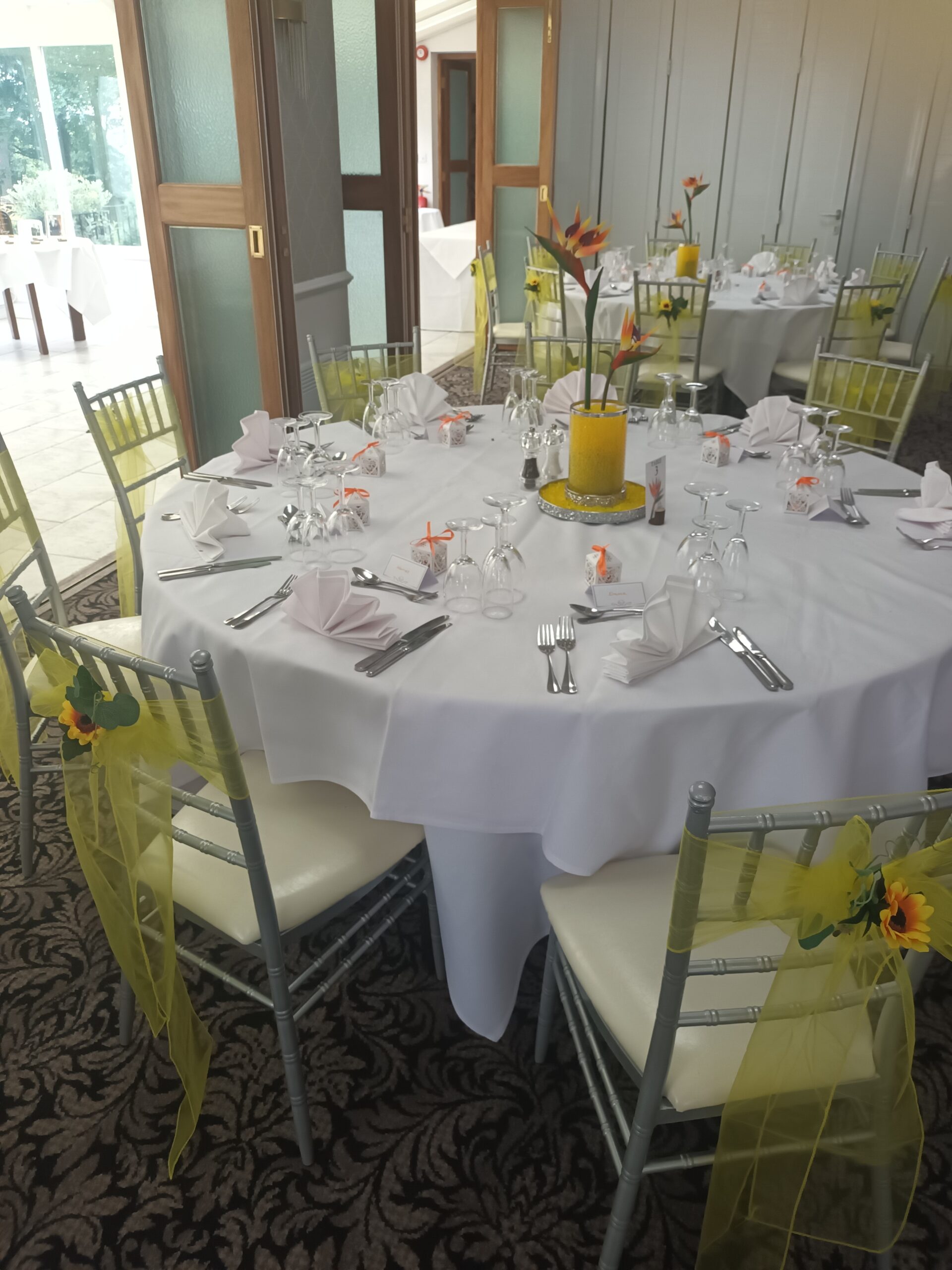 Sunflowers on yellow chair sashes