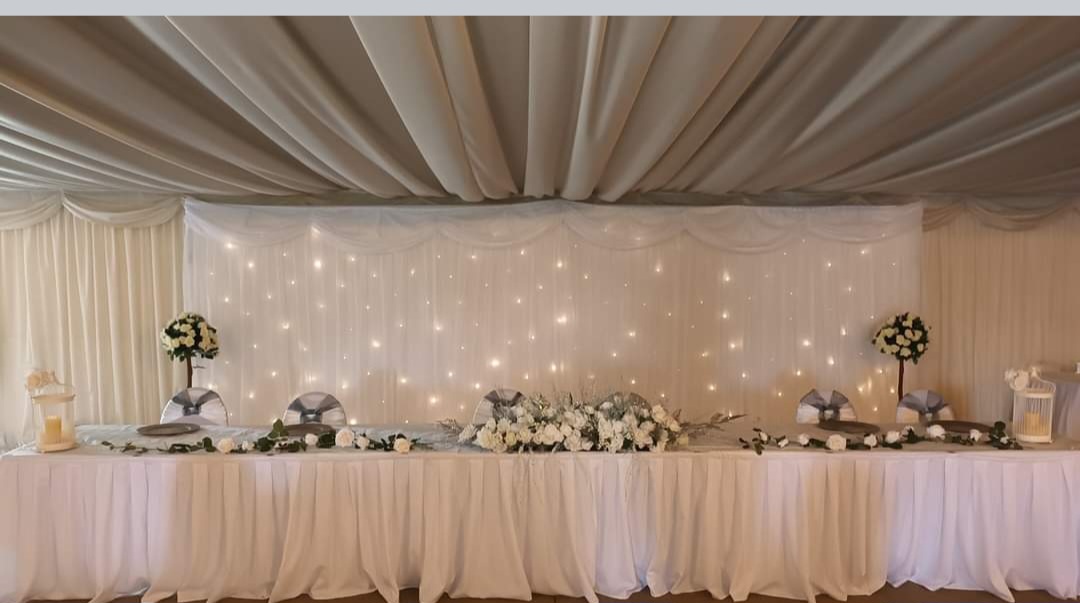 Top table for the winter wedding with starlight sparkle backdrop behind