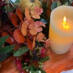 Autumn coloured flowers with a warm light candle from our Harvest Moon top table