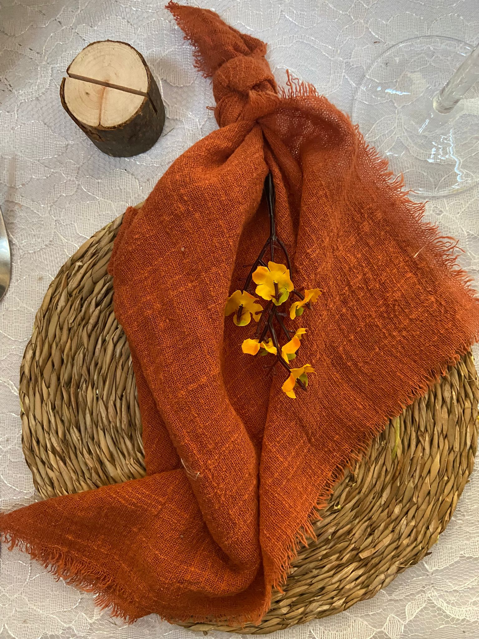 Harvest Moon place setting with wicker charger place and rust orange napkin