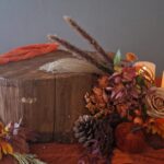 Wedding cake stand, log stump with rust orange runner and autumn flowers