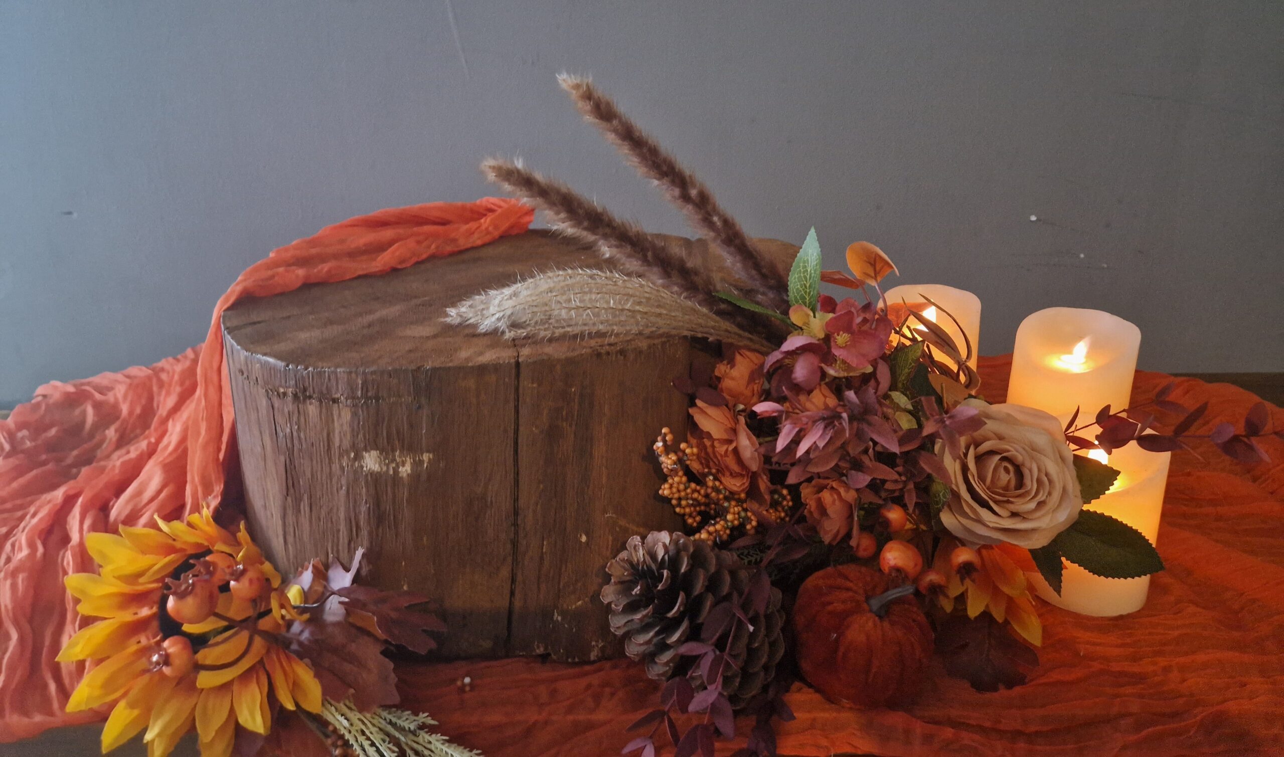 Wedding cake stand, log stump with rust orange runner and autumn flowers
