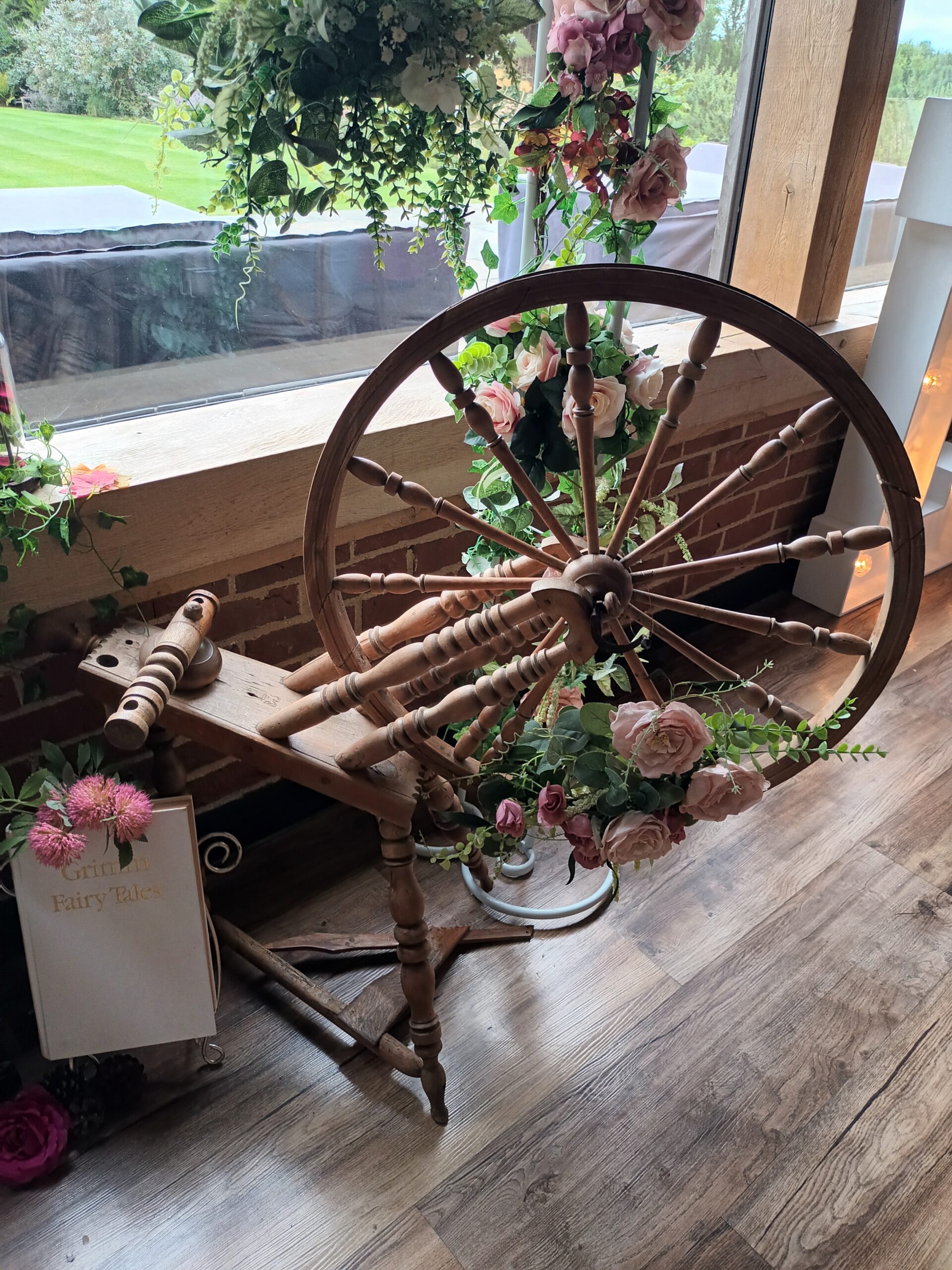 Fairytale wedding vintage spinning wheel decorated with pink flowers